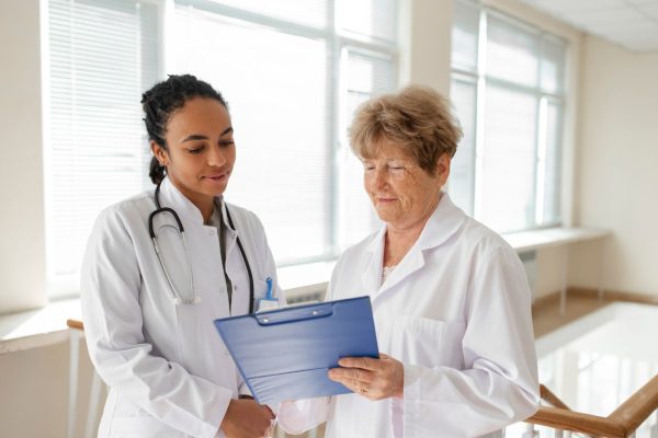 Perita médica Federal atendendo uma paciente idosa